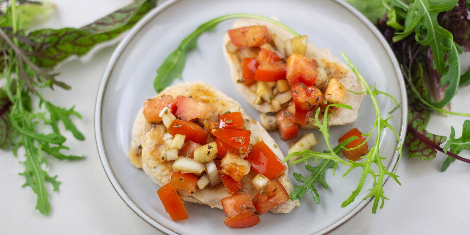 Hähnchen mit Tomaten auf einem Teller